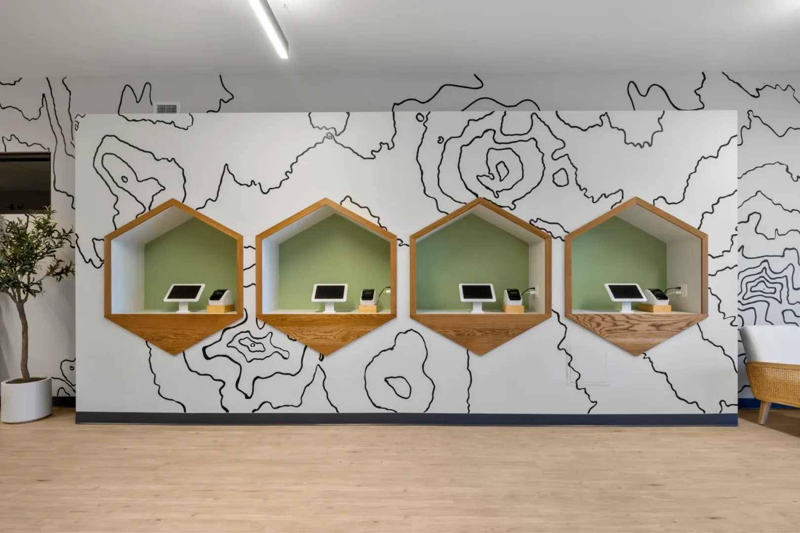 church designer visioneering studios transformed Grace Bible kids check-in space to include a graphic design on the wall and 4 check-in hexagon spots to make check-in a breeze