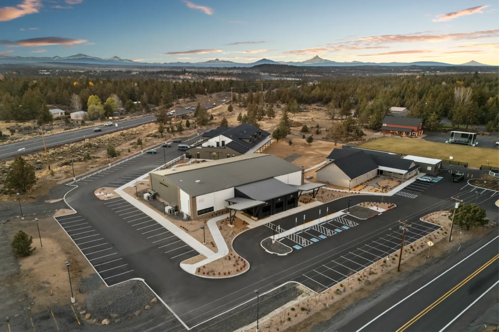 Outdoor courtyard and paved parking area linking new children’s building to existing campus at Graceb ible