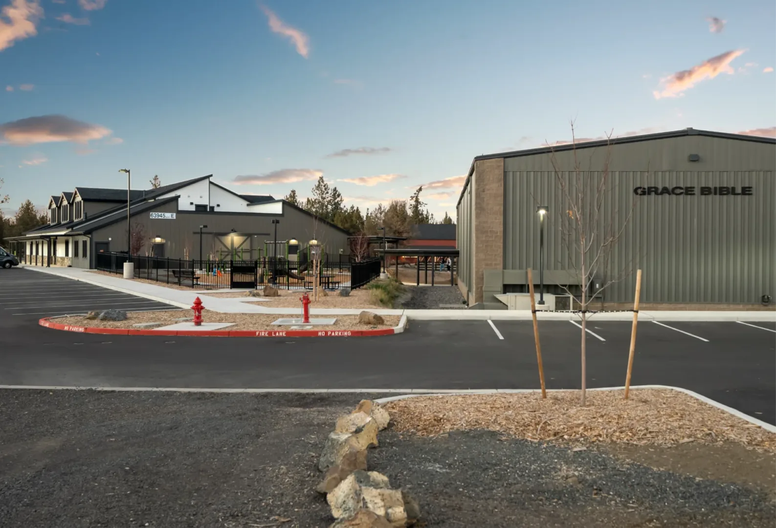 exterior shot of the children's building which you can see part of the playground and other building on campus that all cohesively flows together - church building design by visioneering studios