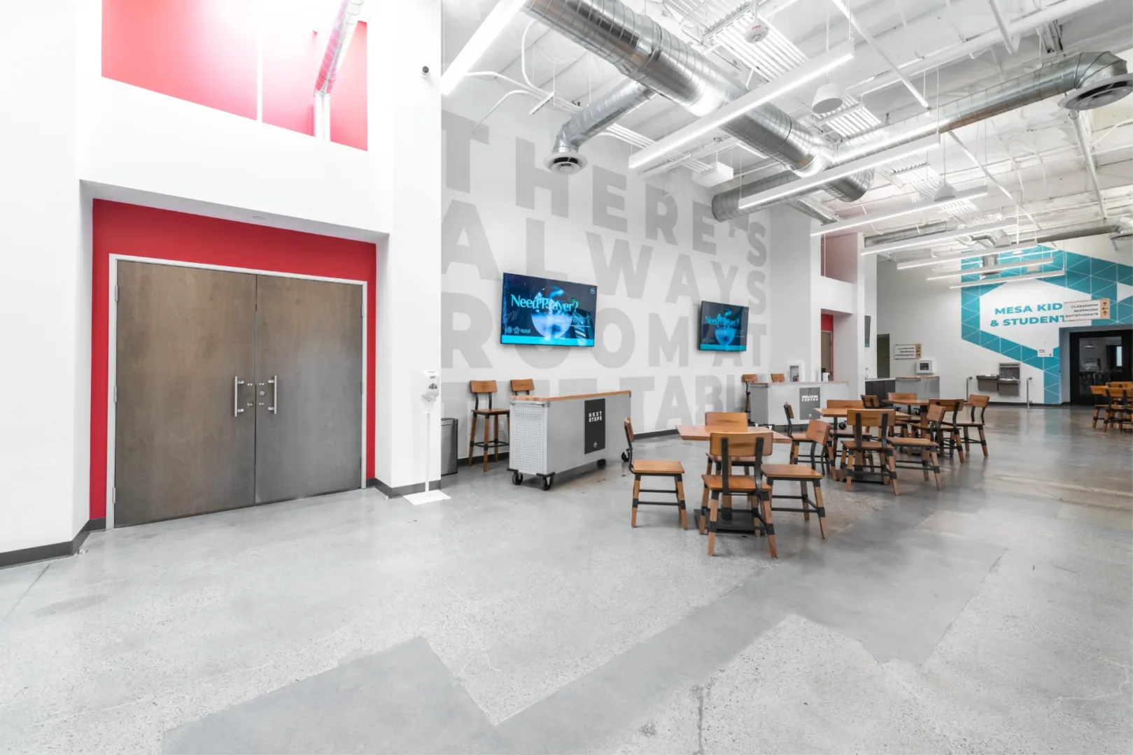build design company visioneering studios highlighting Mesa Church in Irvine, CA interiors of the new lobby with seating areas and new classrooms with wall graphic & wayfinding so parents can drop-off children & students with ease