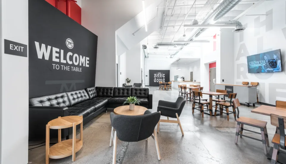 church architecture & builder visioneering studios highlighting Mesa Church in Irvine, CA interiors of the new lobby with seating areas and coffee cafe infront of a new worship center