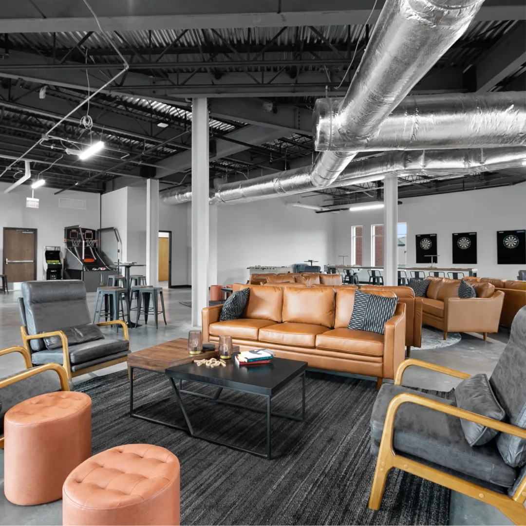 Men’s Bible study hangout space at New Vision Baptist Church featuring games like ping pong, darts, shuffleboard, and comfortable family room seating areas.