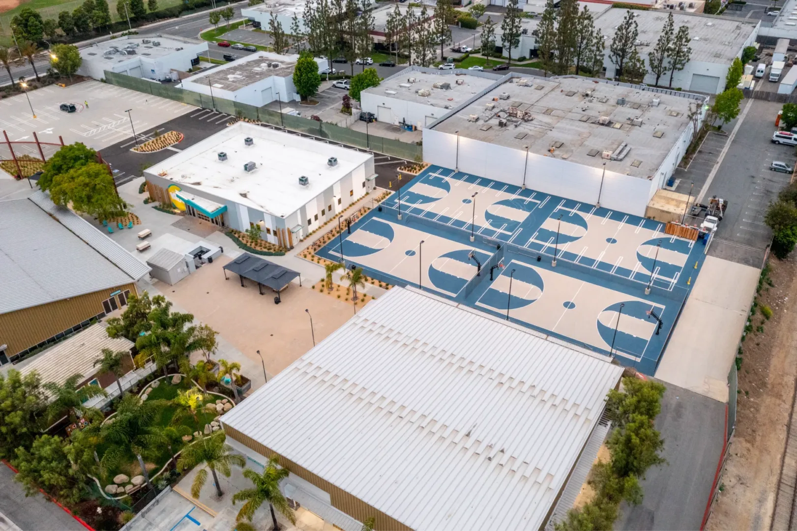 Exterior view of Seabreeze Church campus by church architect Visioneering Studios, showing kids building and basketball courts designed for connection and community engagement