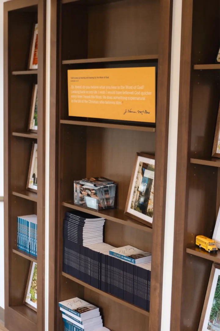 image of bookcase in thru the bible that has a quote in a frame said by Dr. J. Vernon McGee