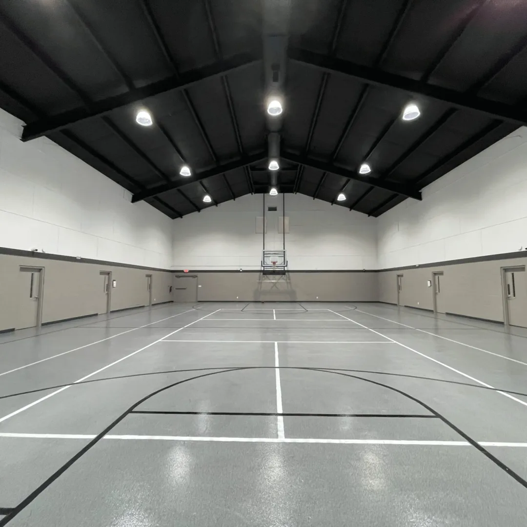 Renovated Journey Church gymnasium repurposed for ministry use with updated finishes, lighting, and multi-use court layout.