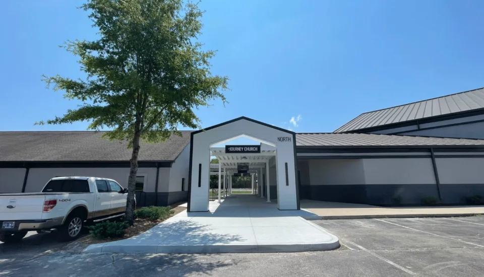 Journey Church campus renovation with redesigned north entrance portal, covered walkway system, and updated exterior architecture by Visioneering Studios.