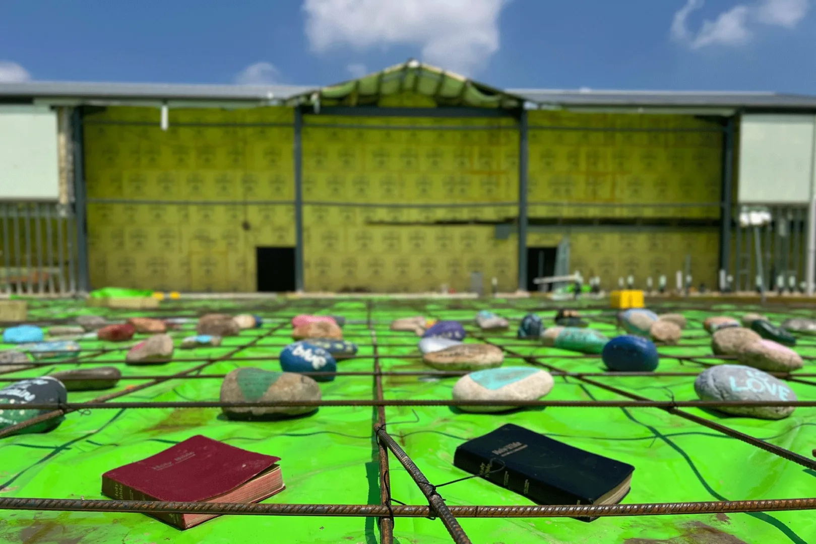 Early-stage church construction site featuring a prepared foundation with symbolic elements placed in prayer before building begins, reflecting church builder Visioneering Studios’ mission-driven design process.