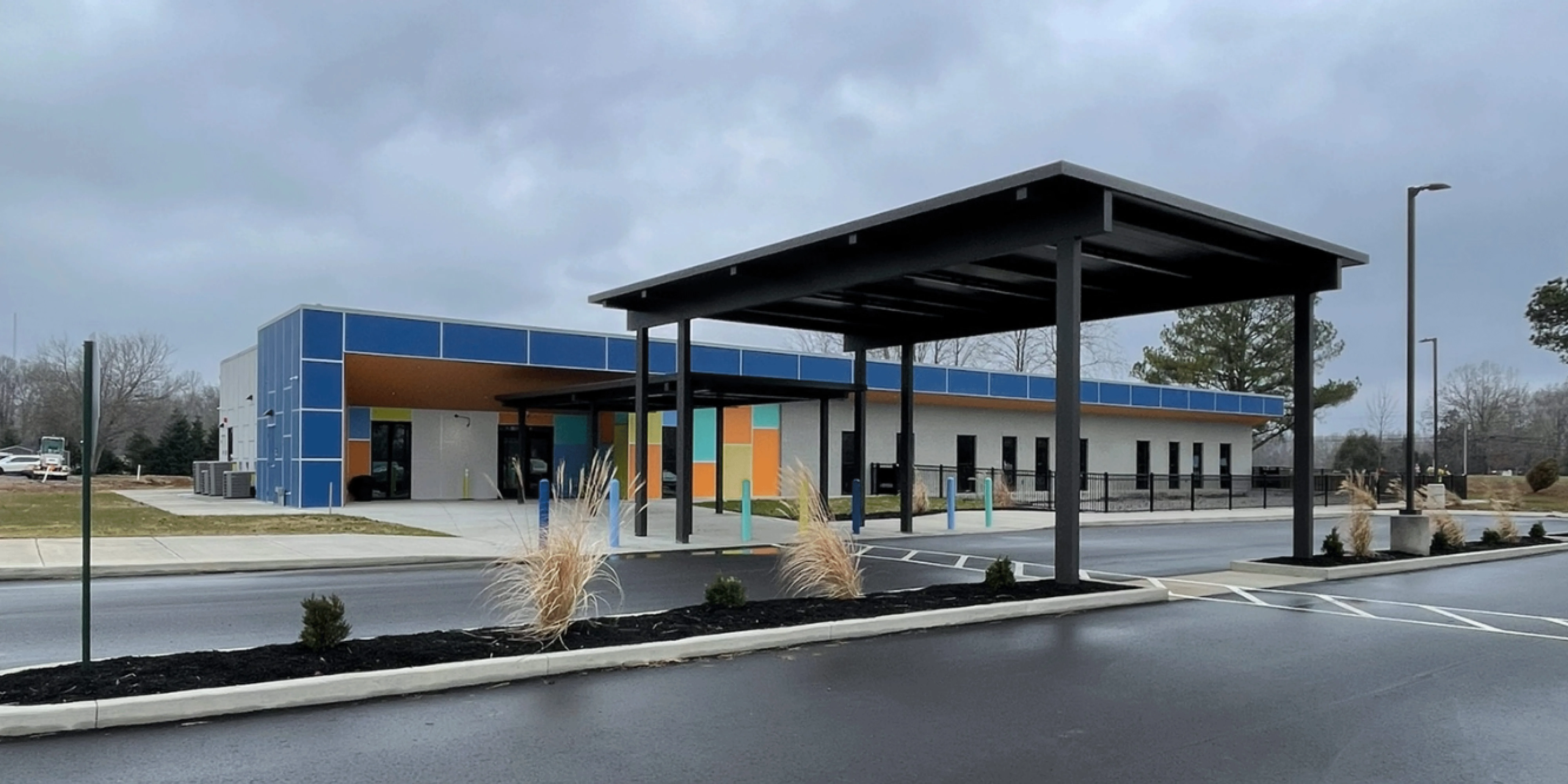 Completed education building design project featuring a modern early learning facility with covered drop-off and student-centered exterior design by Visioneering Studios.
