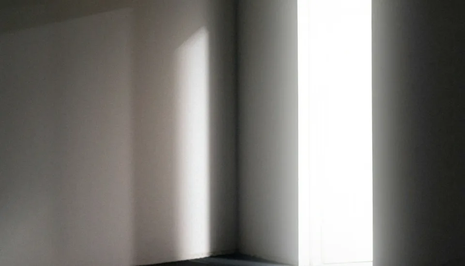 Dark room with an open doorway that is letting light through representing bringing light to common myths church leaders believe when choosing a church architect
